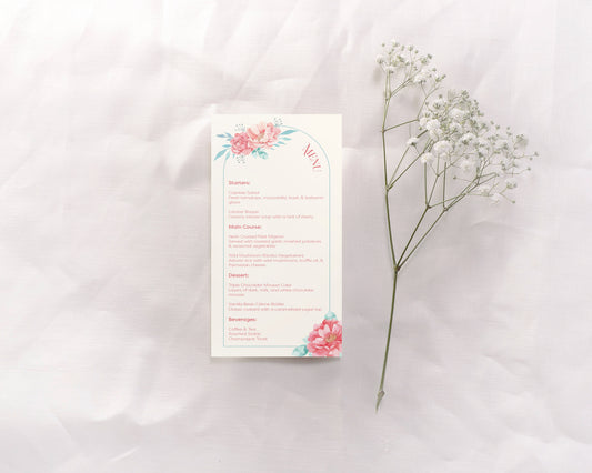 A wedding menu card featuring a soft floral design at the top and bottom, with the word "Menu" elegantly curved on the right side. The card is divided into sections: Starters, Main Course, Dessert, and Beverages, all listed in a clear serif font.