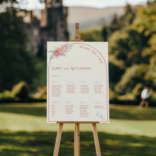 The seating chart is titled "Please Take A Seat" at the top, and the names "Emily and Alexander" are written in elegant red script below it, along with the wedding date "14.09.24." The top left corner of the chart features a floral illustration of pink and peach flowers.